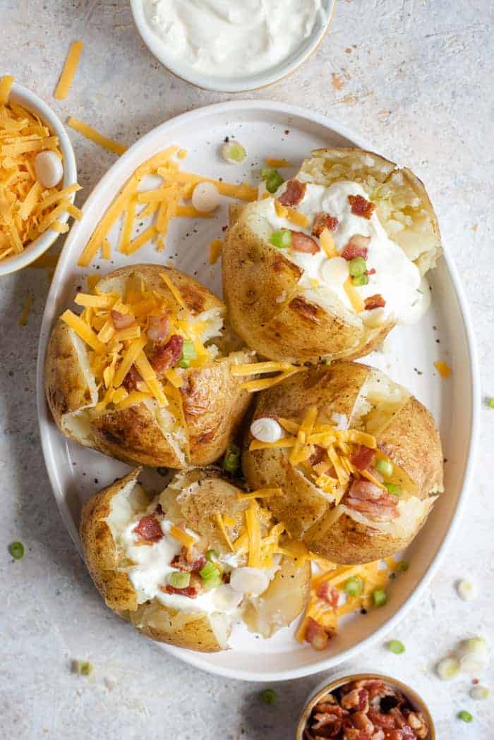 An overhead shot of instant pot baked potatoes on a serving plate