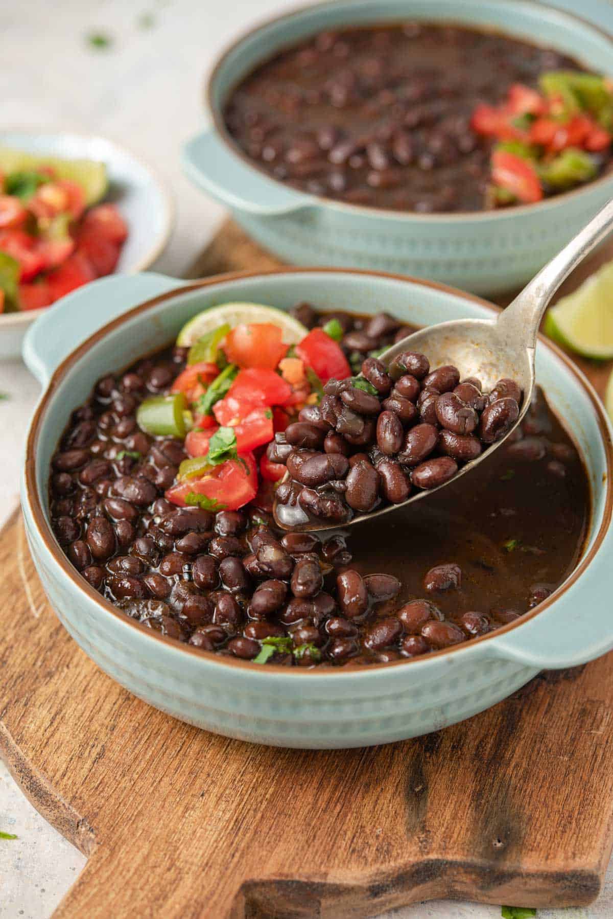A close up of a spoonful of black beans