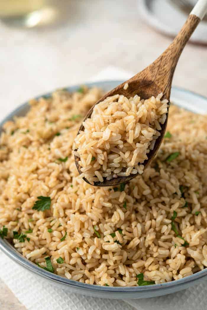 A close up of instant pot brown rice on a serving spoon