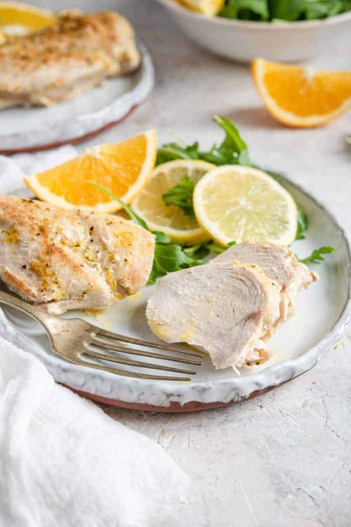 Instant pot chicken breasts cut into slices on a plate with a fork