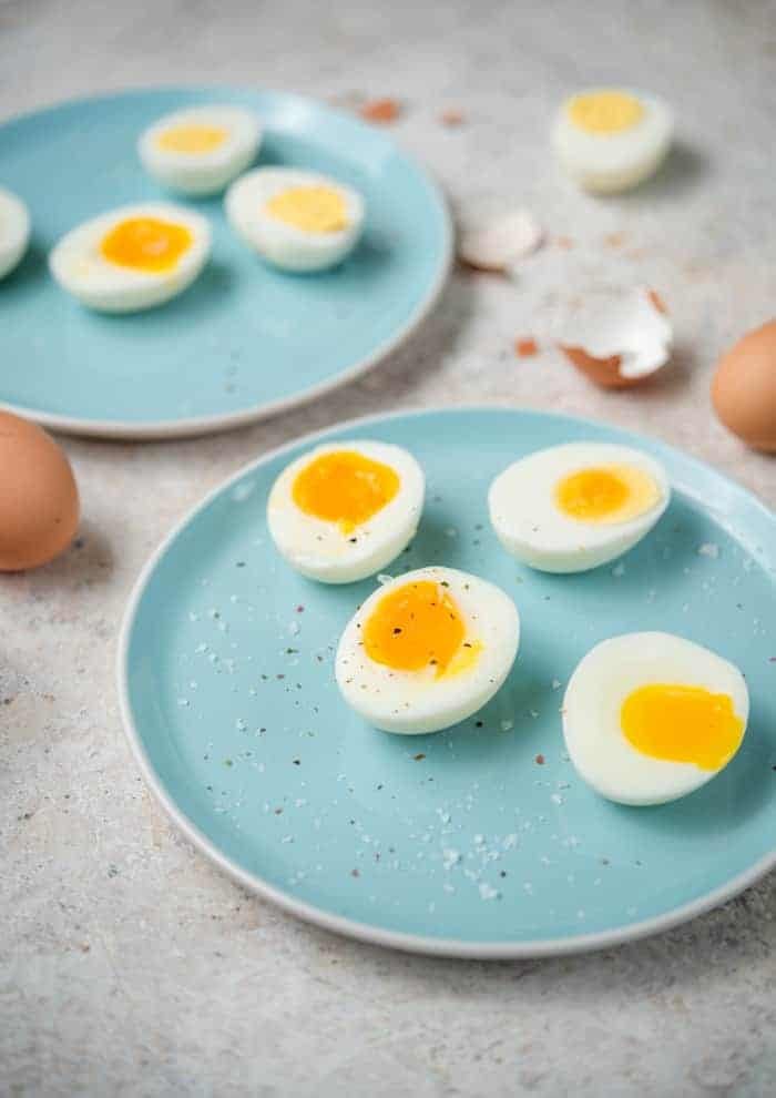Instant pot hard boiled eggs and jammy cooked eggs on blue plates