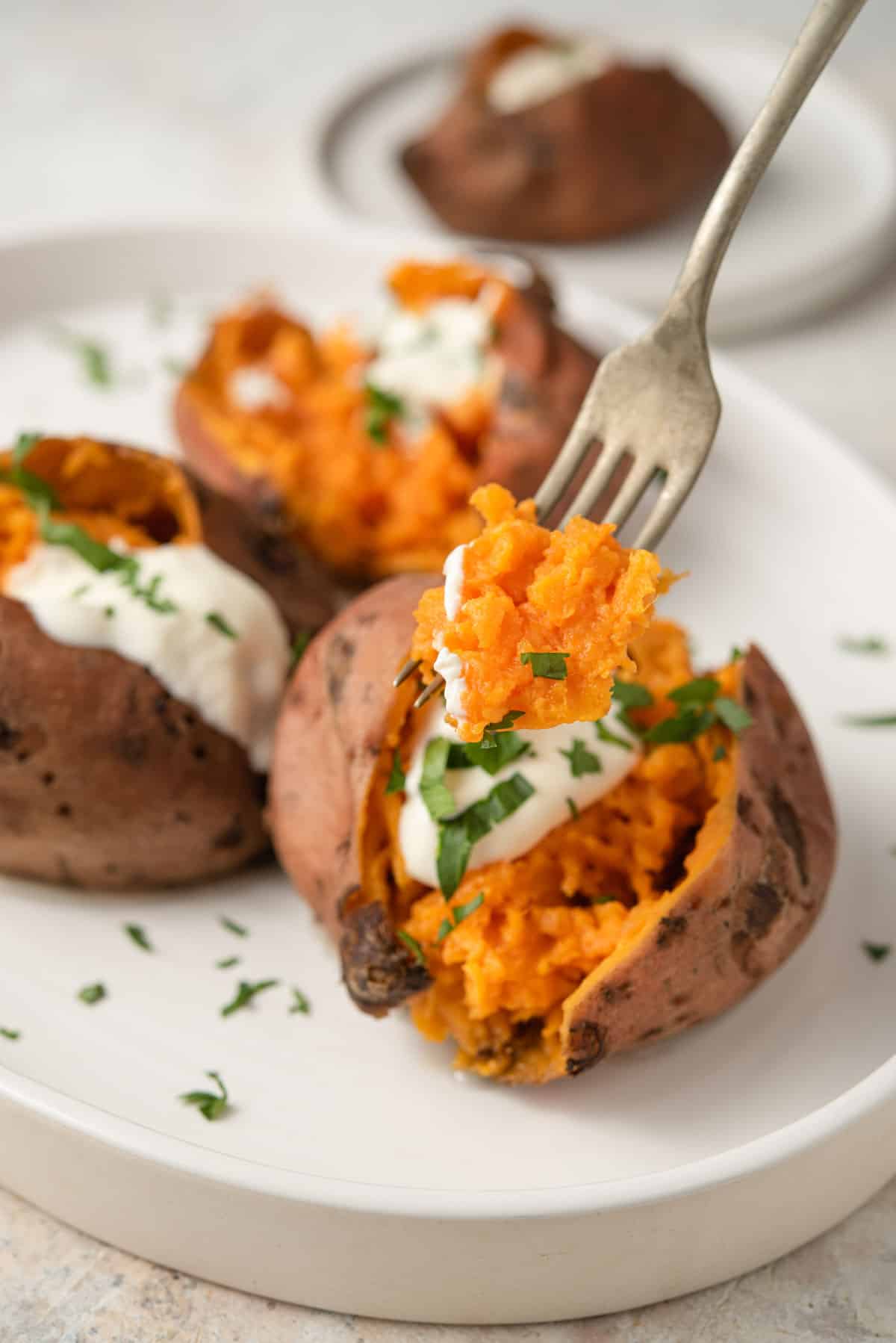 A fork picking up a bite of sweet potato