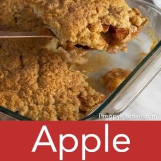 apple cobbler in a glass baking dish with a spoon