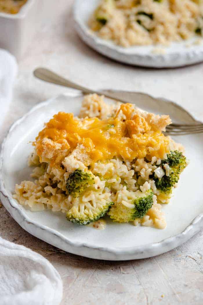 A slice of broccoli casserole on a plate with a fork