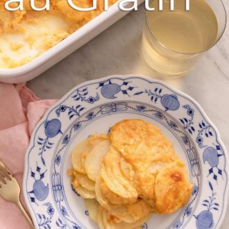 A pinterest graphic of potatoes au gratin, a glass of wine, and a baking dish.
