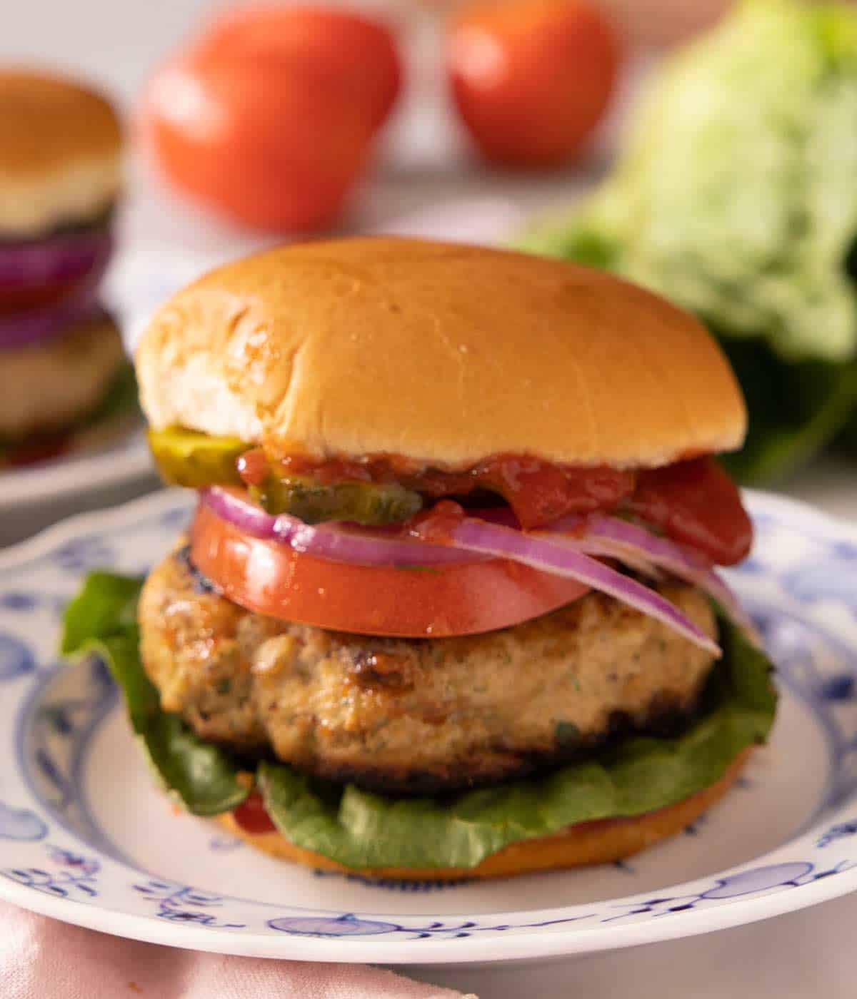 A close up of a Turkey Burger on a blue china plate