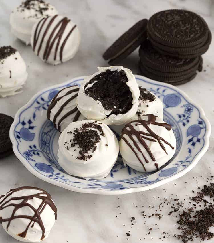 Oreo balls on a blue and white plate on a marble table