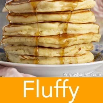 stack of fluffy pancakes on a plate topped with syrup being drizzled