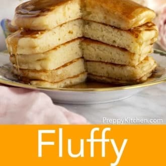 stack of fluffy pancakes on a plate topped with syrup