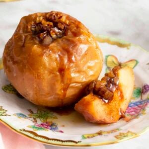 A baked apple on a porcelain plate.