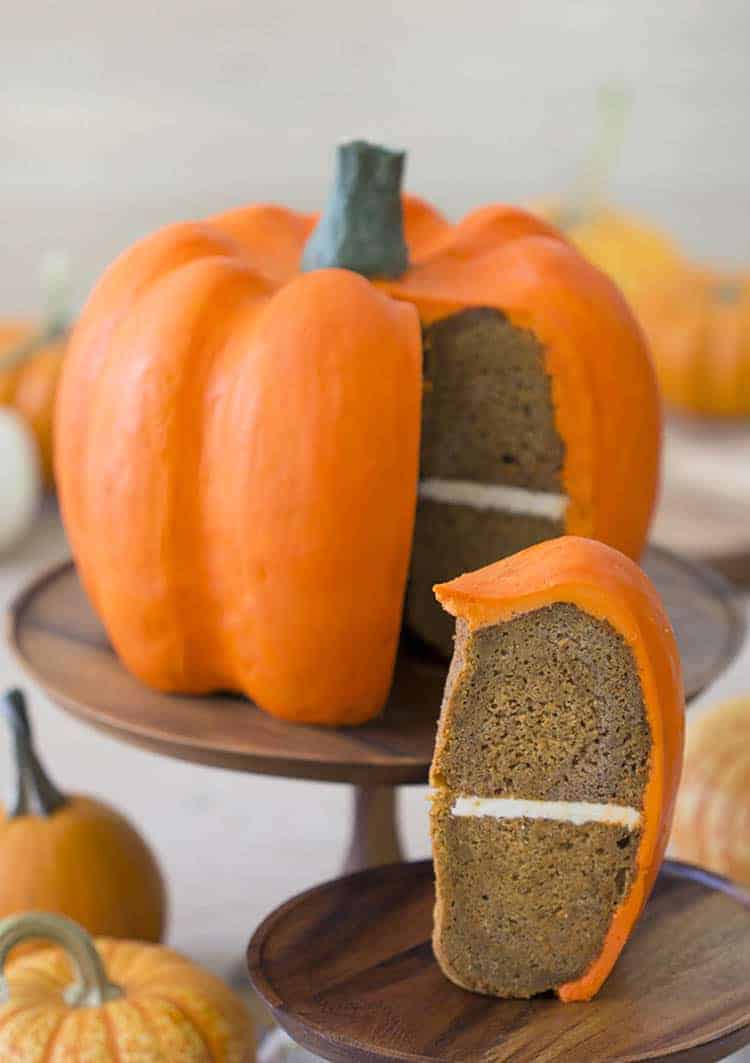 A large pumpkin-shaped cake covered with orange buttercream.