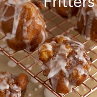 Apple fritters on a copper rack.