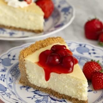 Pinterest graphic of a piece of cheesecake on a plate with berries.