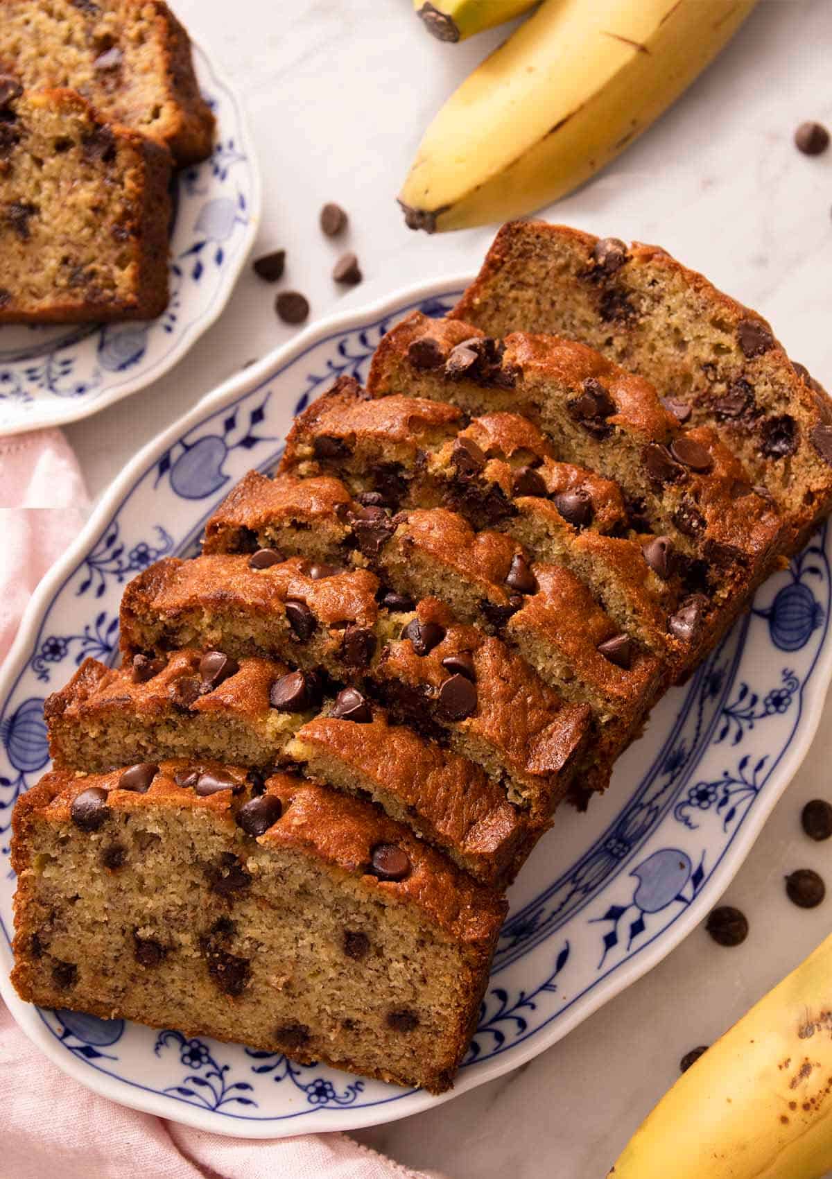 Slices of chocolate chip banana bread on a blue serving plate