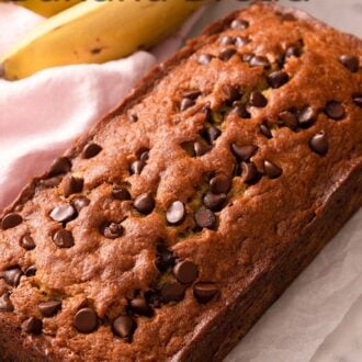A pinterest graphic of a loaf of chocolate chip banana bread.