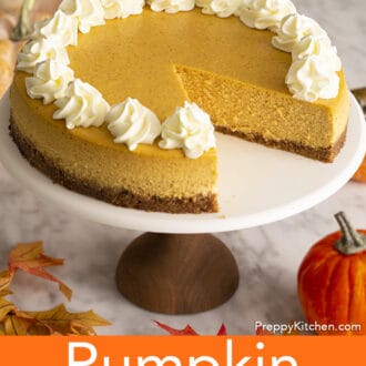 A pumpkin cheesecake on a cake stand.