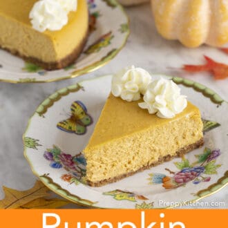 Two pieces of pumpkin cheesecake with whipped cream on plates.