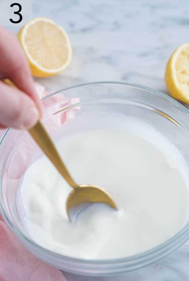 Milk and lemon juice being stirred together.