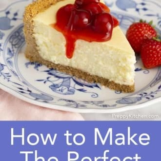 Pinterest graphic of a slice of cheesecake with berry sauce on top and two strawberries on the side.