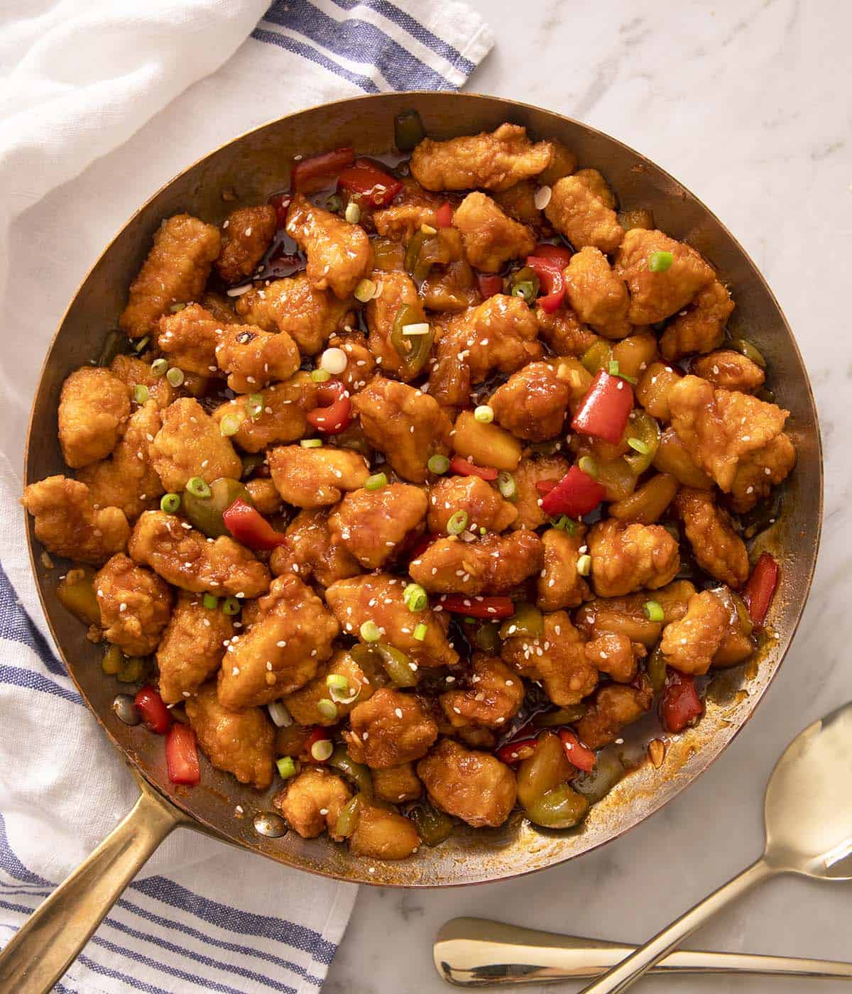 An overhead shot of sweet and sour chicken in a skillet