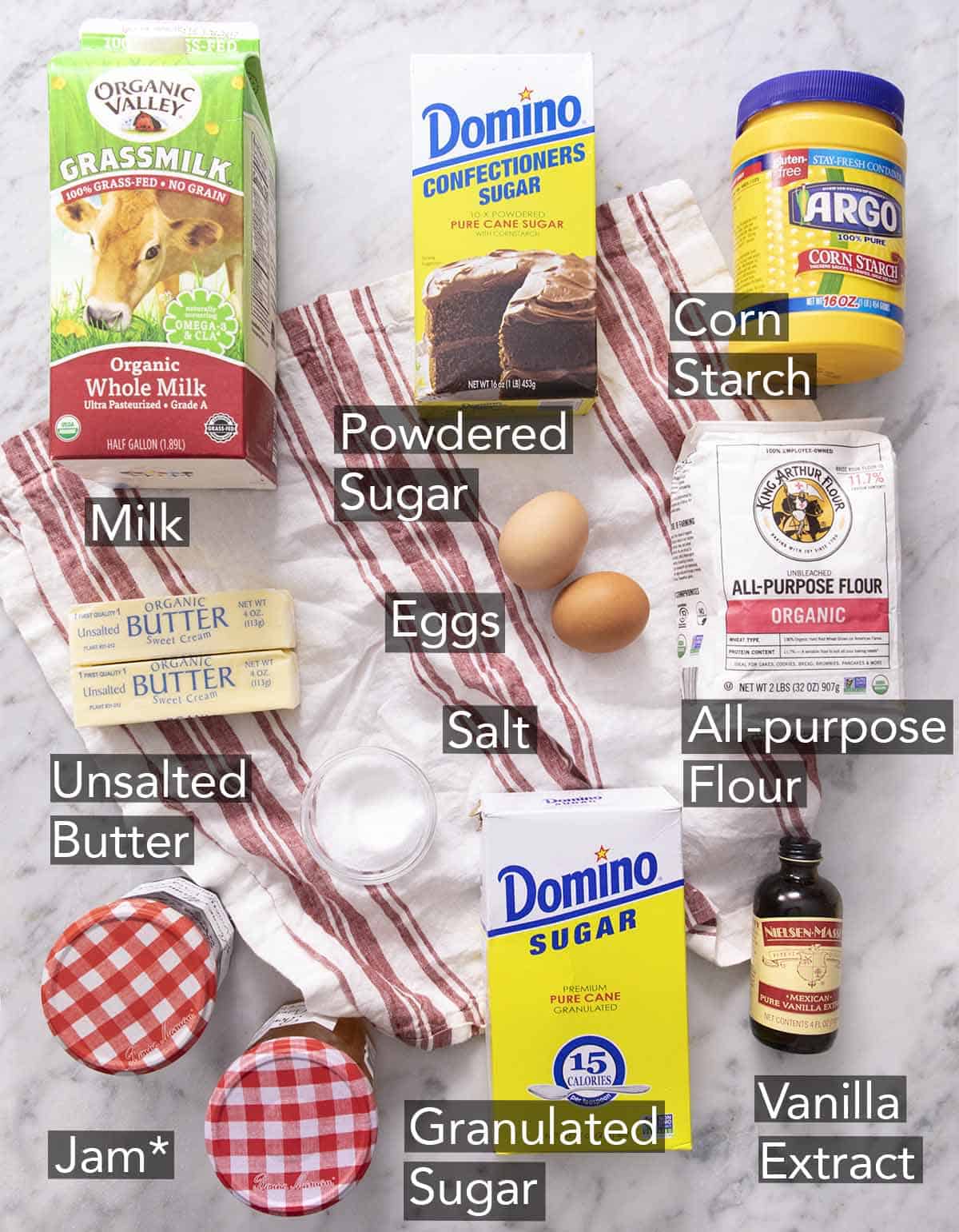 Ingredients needed to make thumbprint cookies on a red and white napkin.