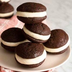 Chocolate whoopie pies on a soft pink plate.