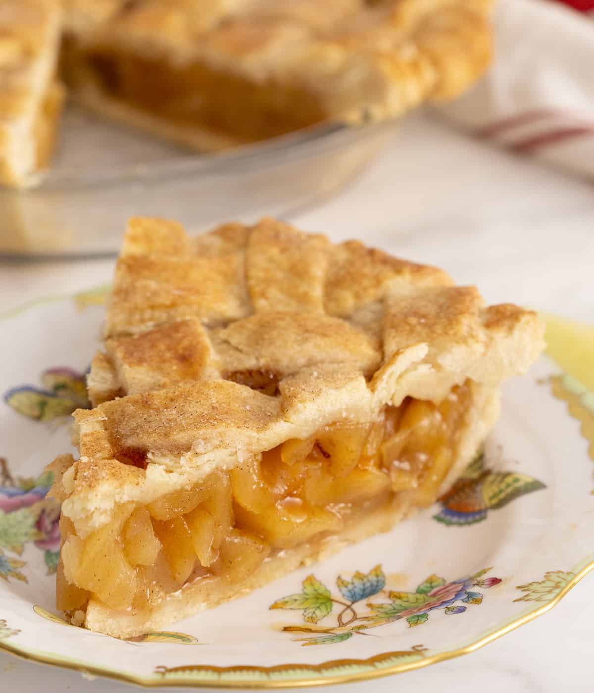 A piece of apple pie topped with a pastry lattice.