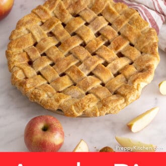 A lattice-topped apple pie fresh out of the oven on a marble table.