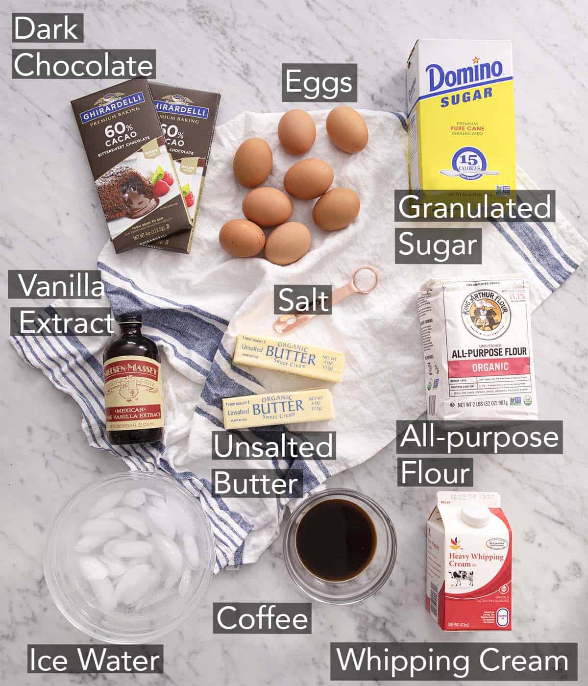 Ingredients to make chocolate pie on a marble counter.