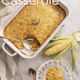 Corn casserole next to some ears of fresh corn.