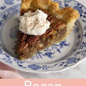 A piece of pecan pie topped with a dollop of whipped cream and some cinnamon.
