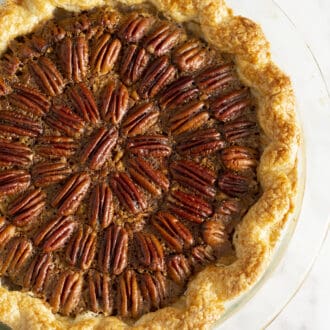A pecan pie on a marble counter.