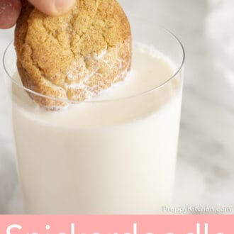 A cookie getting dipped into a glass of milk.
