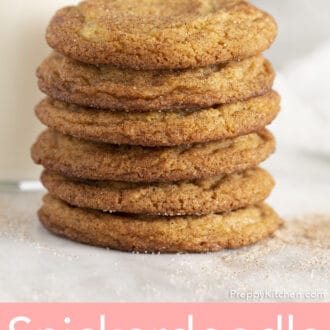 A stack of snickerdoodle cookies in front of a glass of milk.