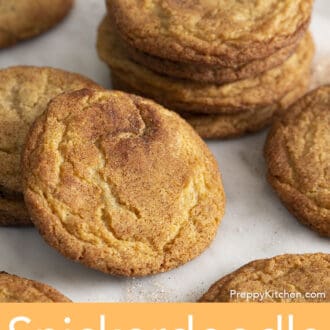 A group of snickerdoodle cookies on a sheet of white parchment paper.