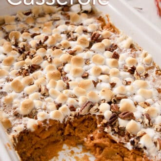 A delicious Sweet Potato Casserole topped with marshmallows in a white baking dish.