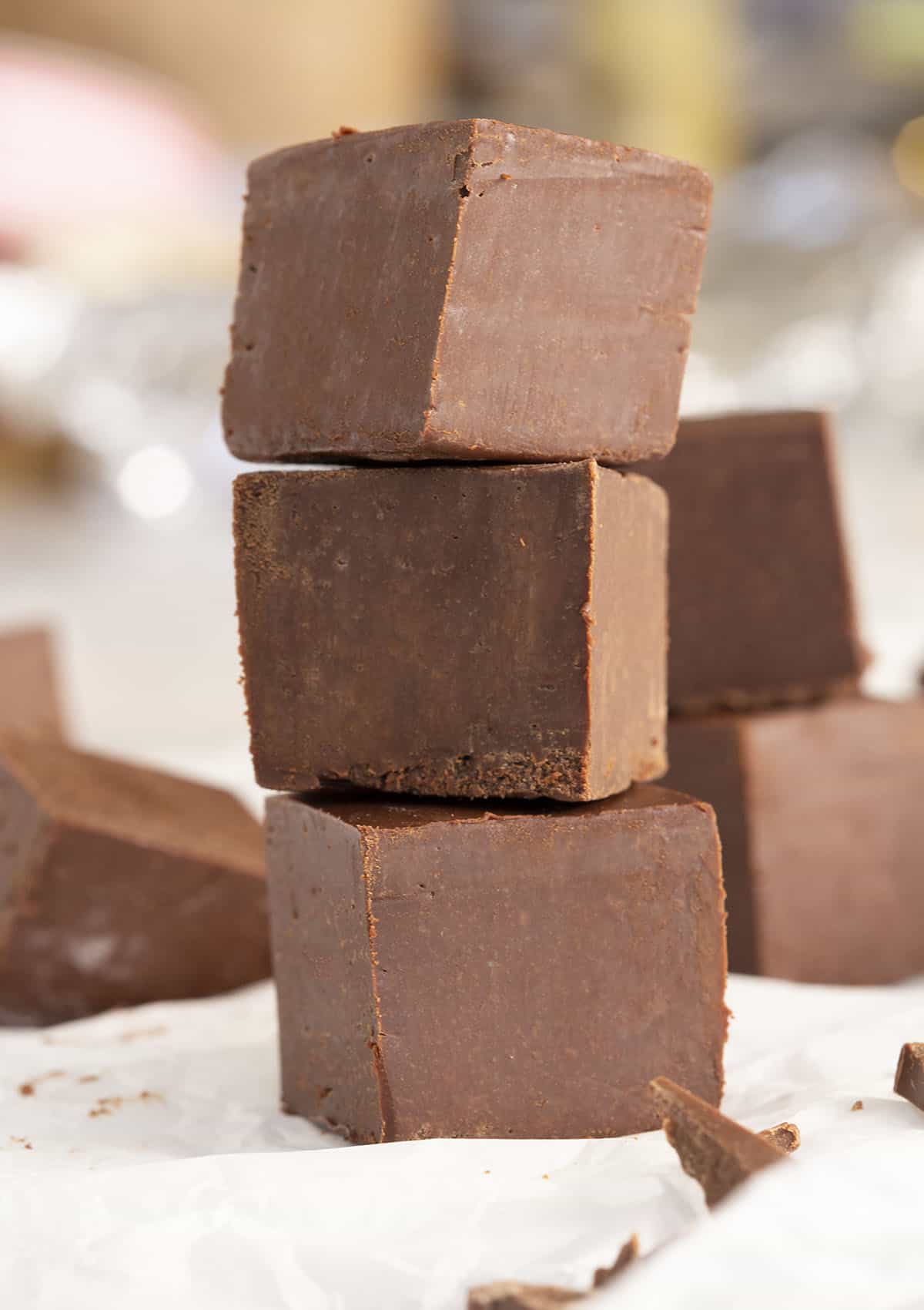 Three cubes of chocolate fudge stacked vertically.