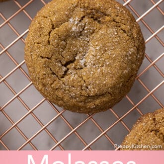 Molasses cookies on a copper rack.