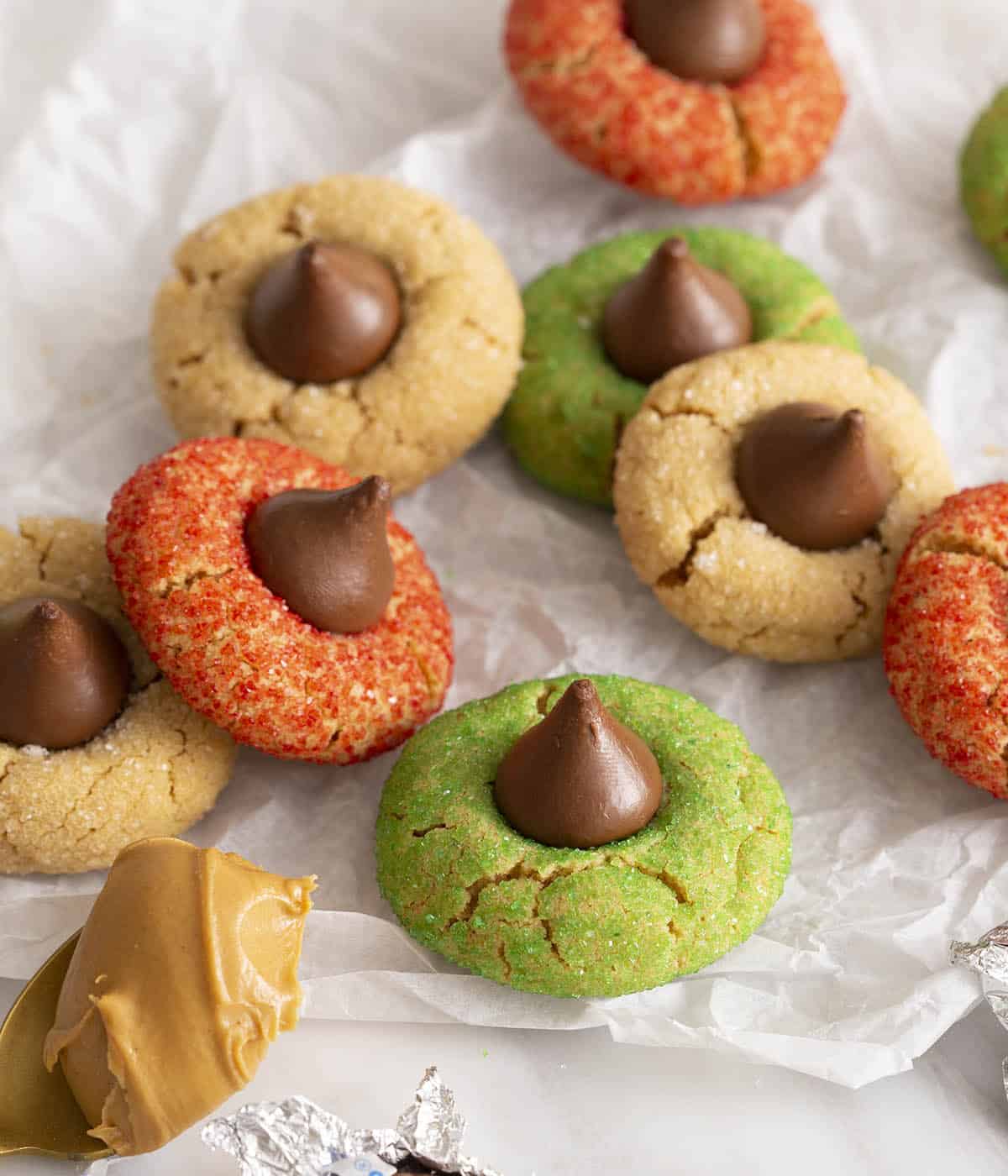 Peanut butter blossoms covered in red, green and white sanding sugar.