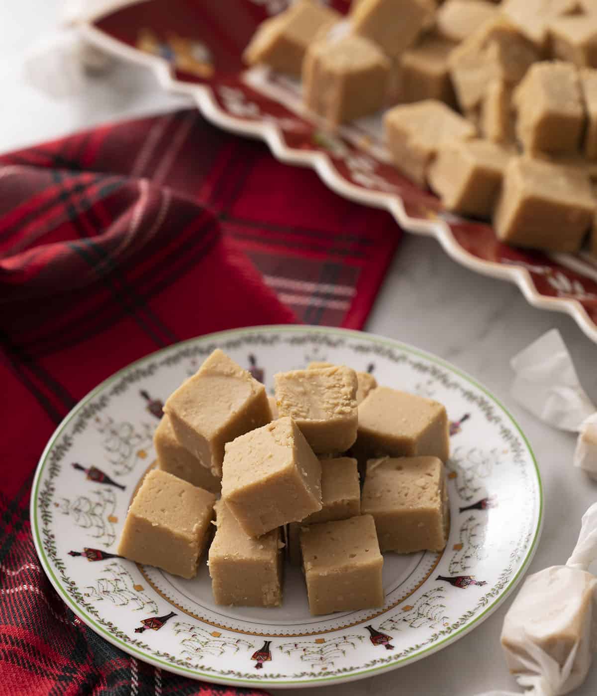 A pile of peanut butter fudge on a holiday plate.