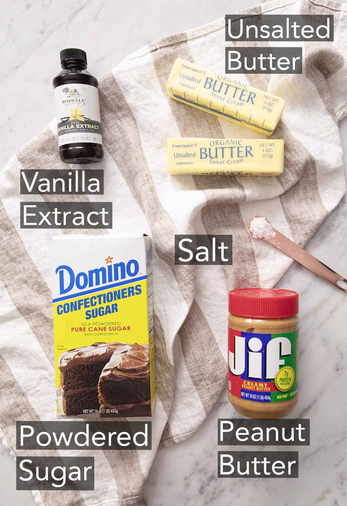 Ingredients to make peanut butter fudge on a marble counter.