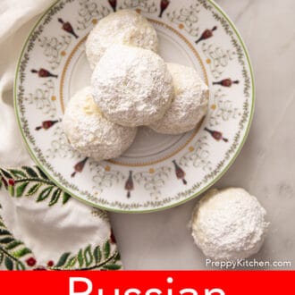 russian tea cakes on a plate decorated with a christmas scene