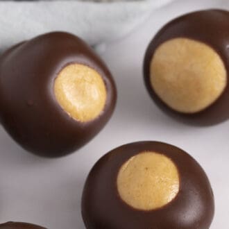 close up of 4 buckeyes on a white surface