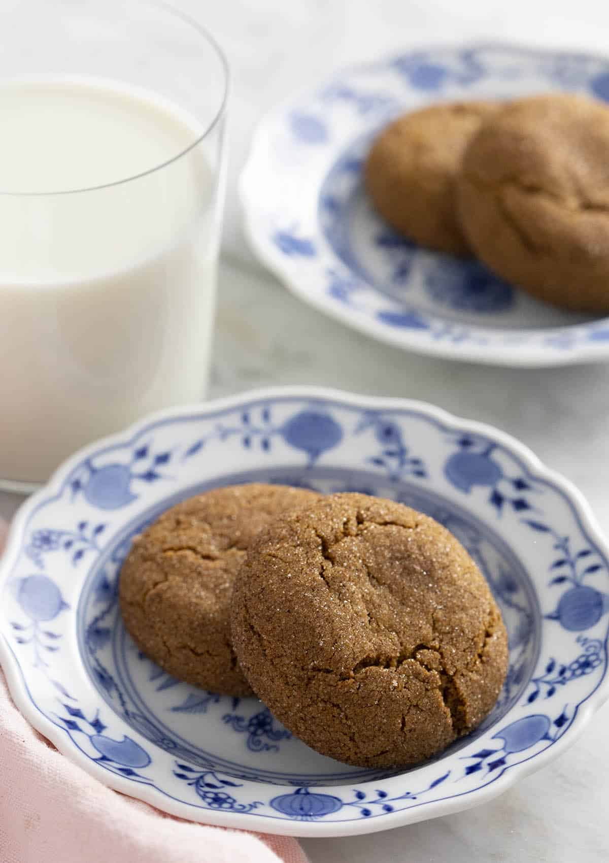 Ginger snap cookies on blue and white plates.