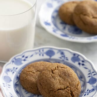 gingersnap cookies sitting on a blue and white plate