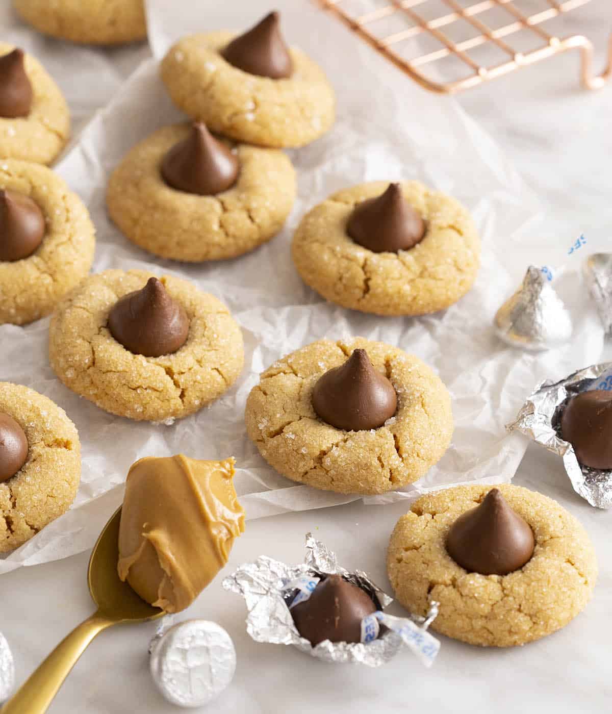 A group of peanut butter blossom cookies on a marble table.
