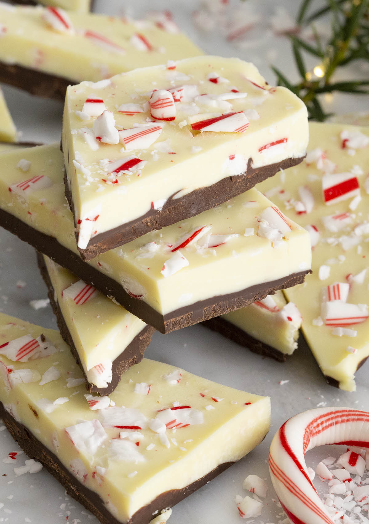 Peppermint Bark stacked next to a candy cane.