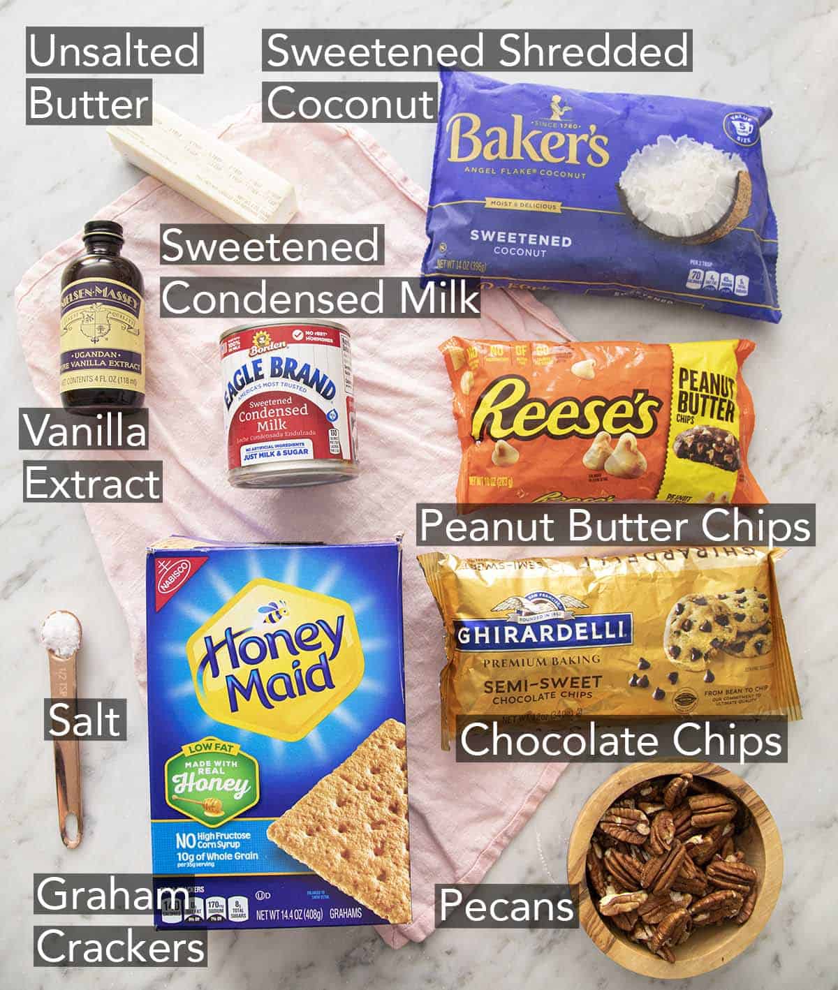 Ingredients to Make Magic cookie bars on a marble counter.