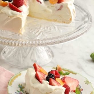 piece of pavlova topped with berries on a plate
