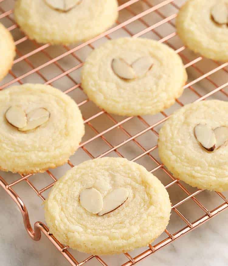 Almond cookies on a wire cooling rack.